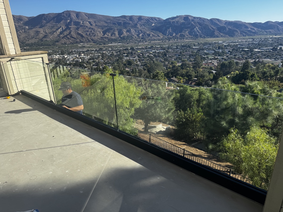 Glass balcony railing with panoramic mountain view