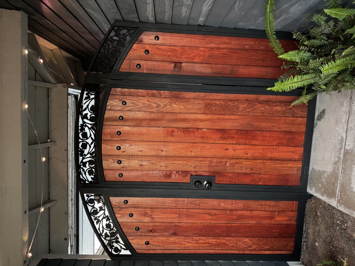 Custom wood and iron entry gate with ornamental details