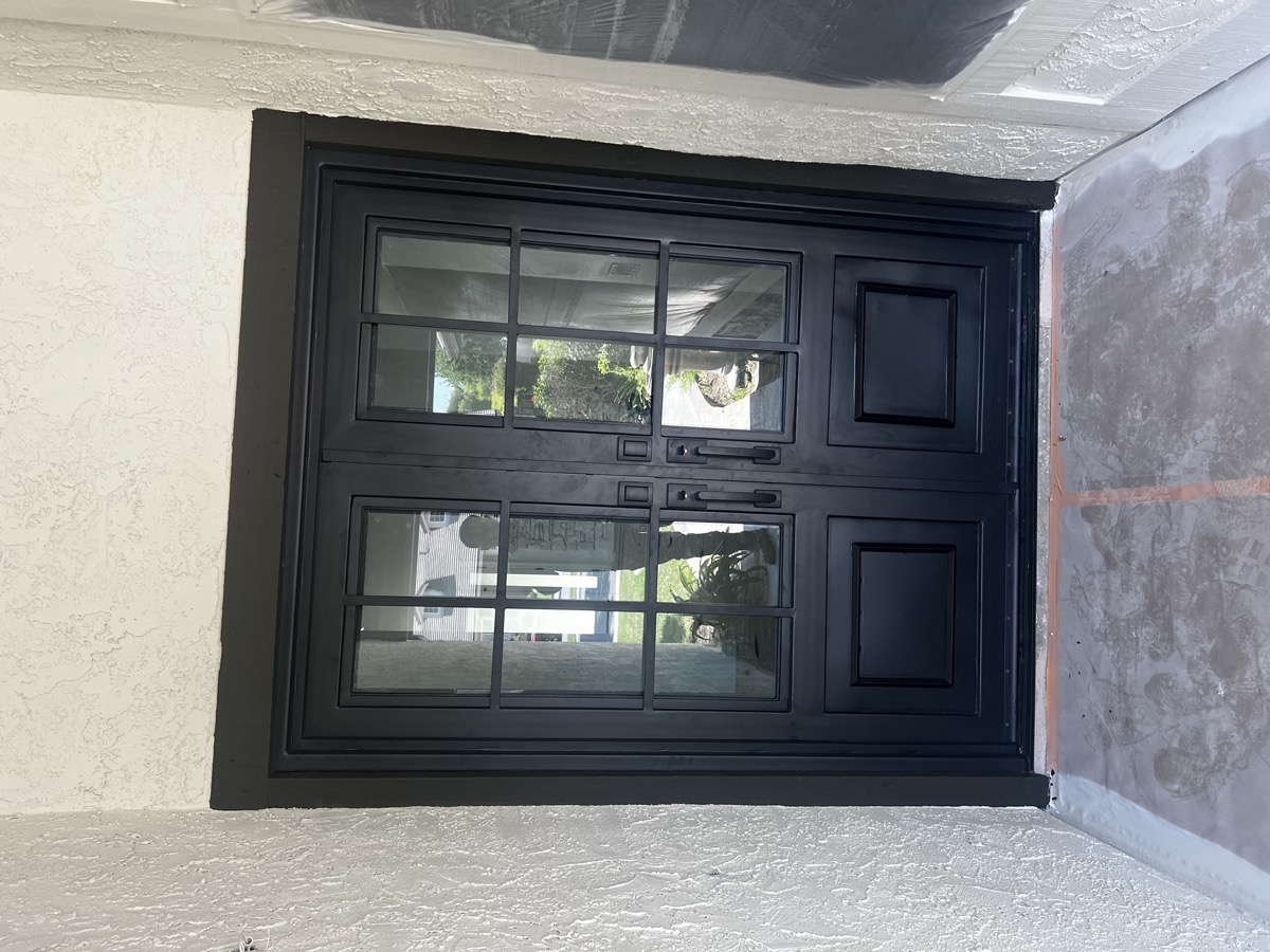 Modern black metal front door with glass