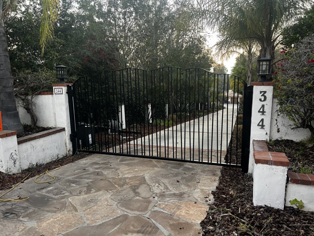 Classic black iron driveway gate on Spanish-style estate in Ventura County