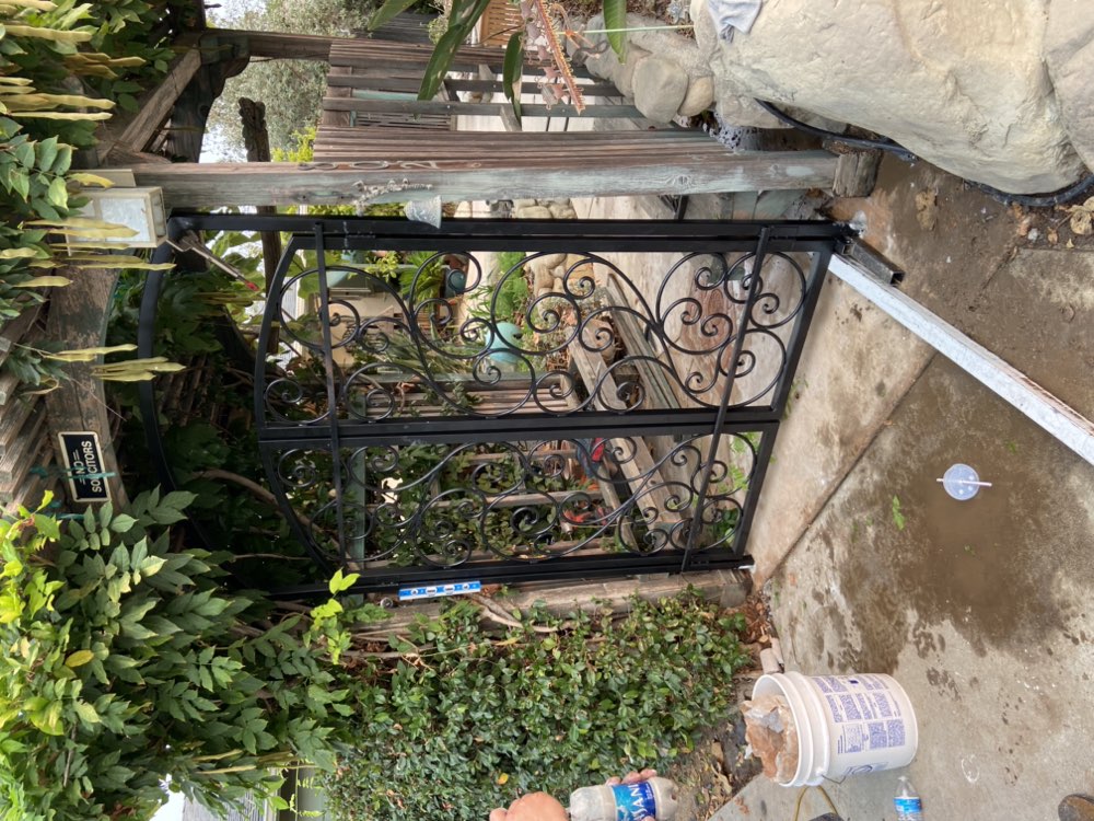 Ornamental wrought iron garden gate with scrollwork by Legendary Metal Works